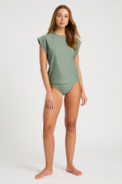 Model in studio wearing khaki Sleeveless UPF50+ rashie with matching bikini bottoms