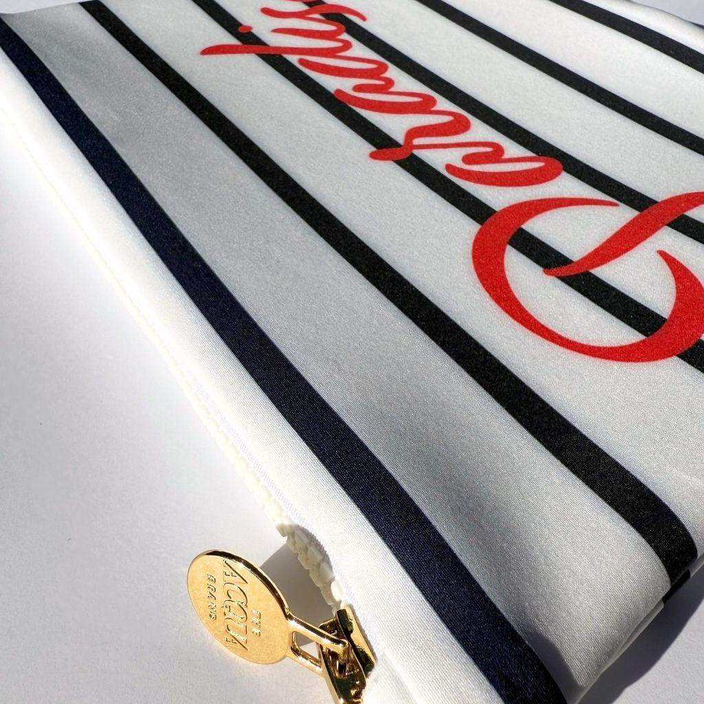 Nautical stripe zip pouch with Paradiso in red written across it