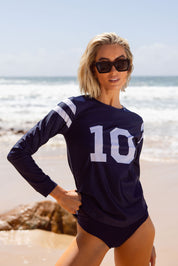 Front view of model on beach wearing Perfect 10 UPF50+ relaxed fit rash vest