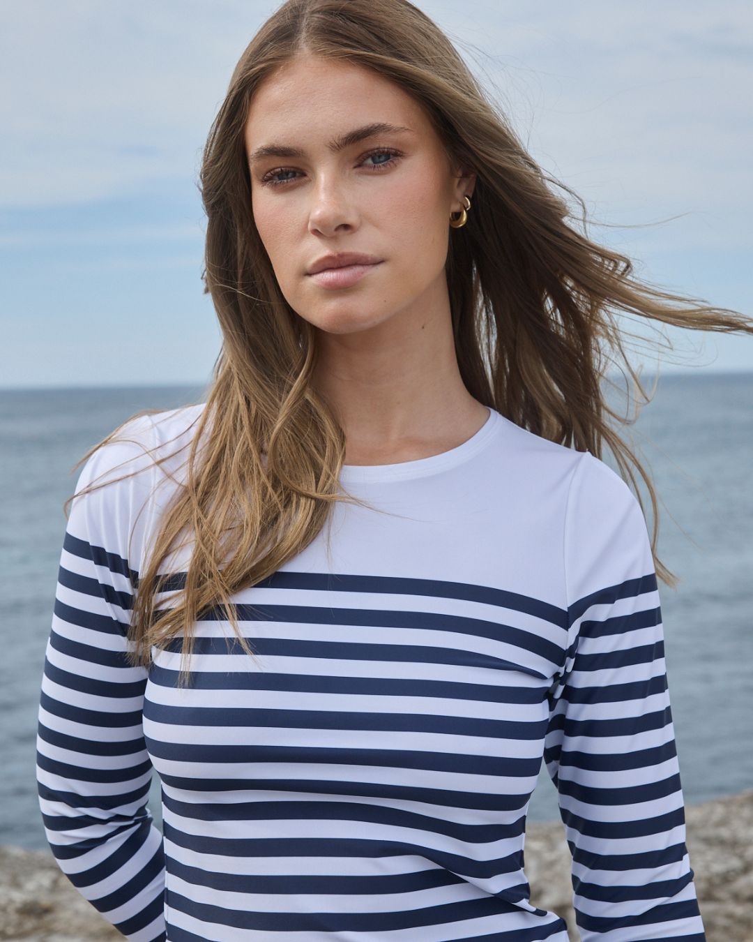 Close-up of white nautical rashguard fabric and stripe detail